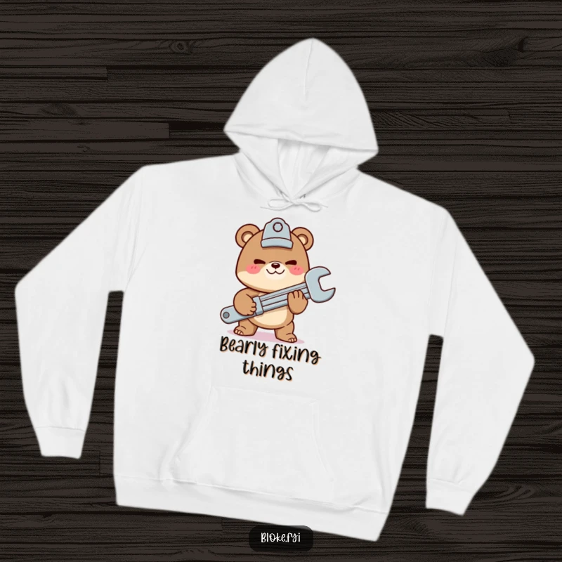 Funny hoodie with a mischievous bear character offering a giant wrench, providing cozy warmth and mechanic humor.