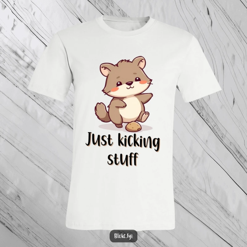 Funny T-Shirt: Scruffy animal comically kicking a small pebble, a humorous depiction of minor displeasure.